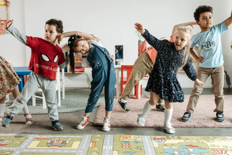 A grounp of young children dancing at nursery