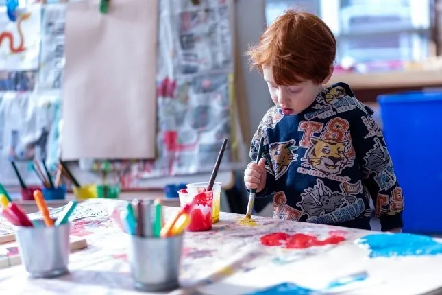 A child painting on a table