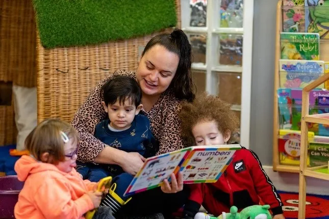 A woman reading to children