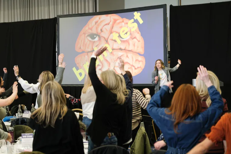 Photo of conference attendees participating in an activity during the keynote speech at the Children at the HEART Spring Conference 2024