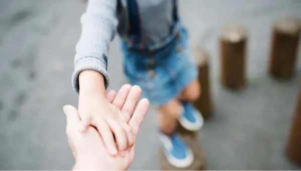 Child taking adult's hand