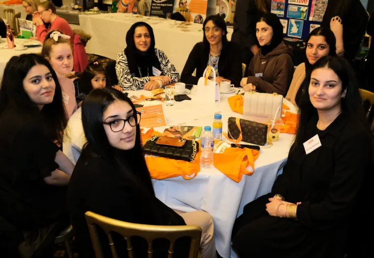 Group of women sat around a table