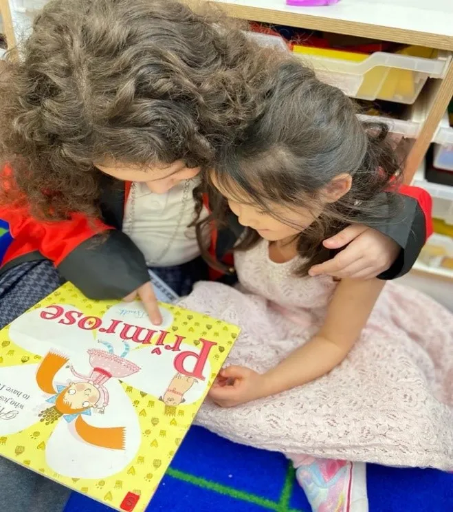 Adult with child reading a book