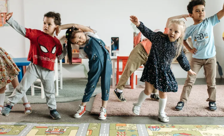 A grounp of young children dancing at nursery