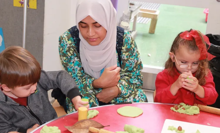 Adult supporting two early years children 