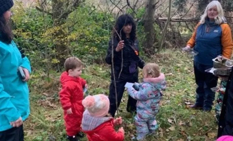 Early years children in a woodland setting
