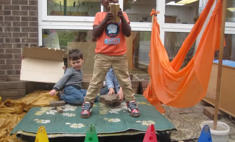 Child standing on outdoor toys