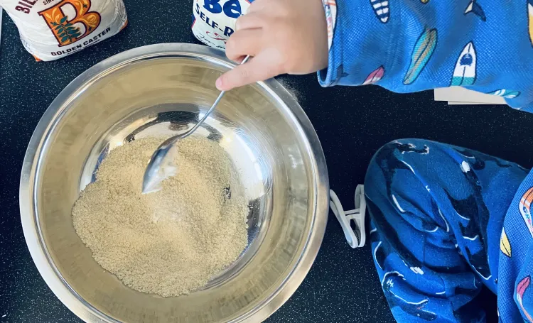 A child baking with baking items around