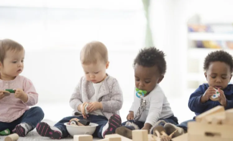 Four babies sat with counting toys 