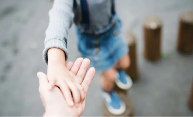 Child taking adult's hand
