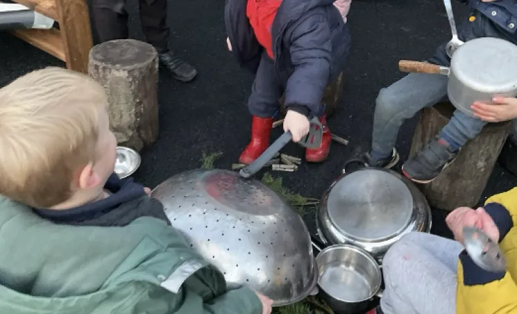 Image of children using pots and pans to make music