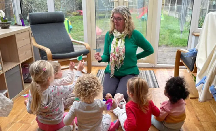 Childminder and teacher on the floor