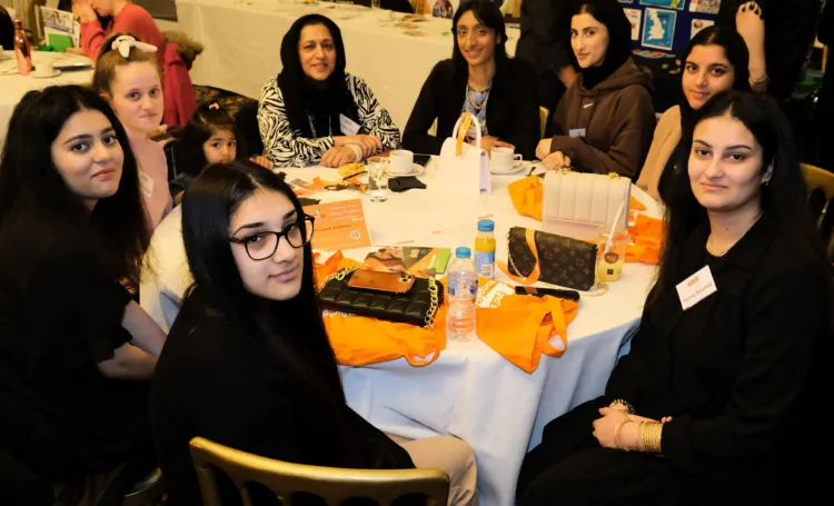 Group of women sat around a table