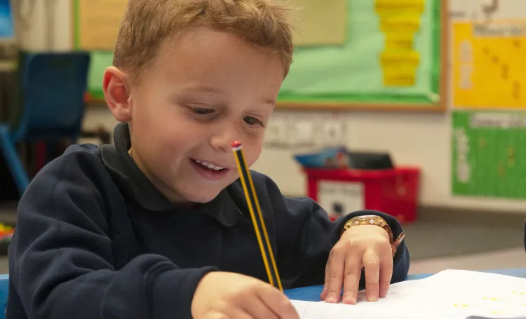 Young people drawing with a pencil in a classroom 