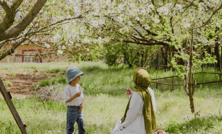 Adult and Child Sitting Under a Tree