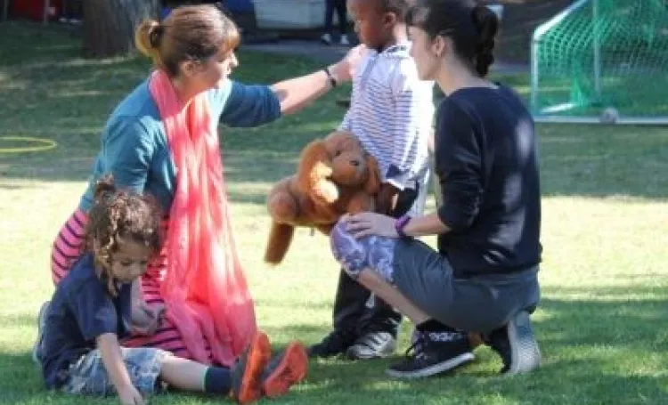 An early years practitioner comforting a child who is upset
