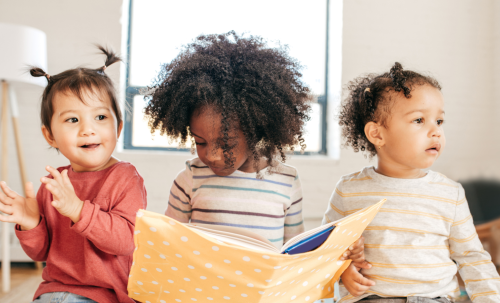 Early years children with book